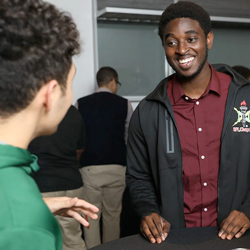 Student meets with a recruiter at a career fair