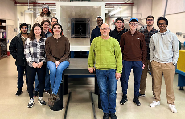 Professor and his research group pose for photo