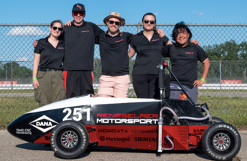 Students pose with their motorsport car