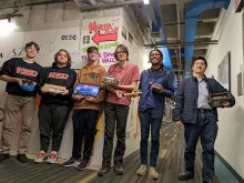 Student pose with their inventions after a content at the Mercer XLab